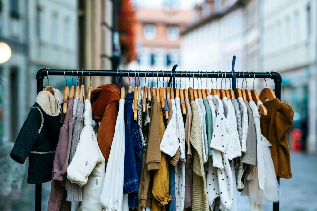Small garments hanging on clothes hangers for white label baby clothes