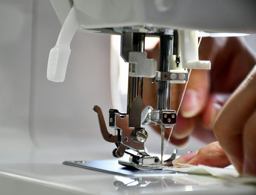 Garment being stitched on an industrial sewing machine for OEM baby wear production