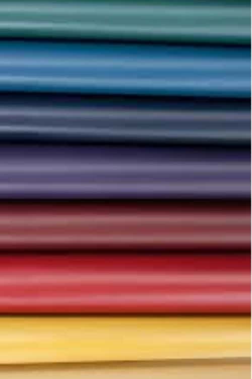 A neatly stacked assortment of colorful fabric rolls in various shades.