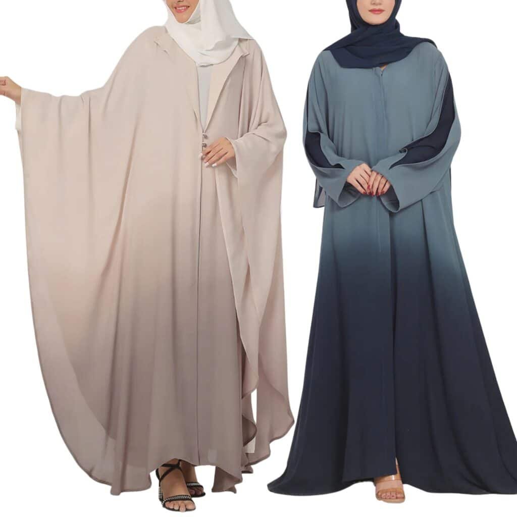 Two women wearing stylish, flowy abayas. The woman on the left is in a light beige abaya with a button closure and a white hijab. The woman on the right is in a dark blue ombre abaya with black sleeves and a navy hijab.