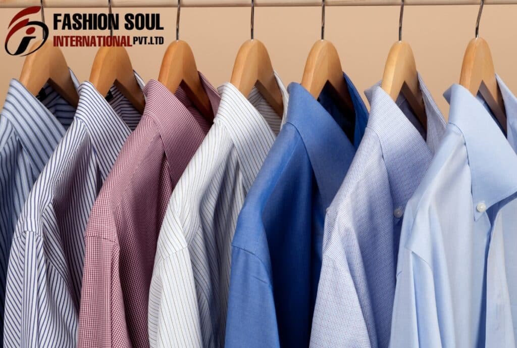 A row of neatly hung men's dress shirts in various shades of blue, white, red, and patterned designs on wooden hangers, with a "Fashion Soul International Pvt. Ltd." logo in the top left corner.
